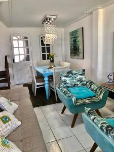 a living room with a couch and a table at Linda casa frente mar pé na areia praia Flamengo in Salvador