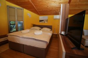 une chambre avec un grand lit et une télévision à écran plat dans l'établissement Villa Monterose, à Malija 29 autres photos
