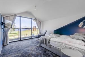 a bedroom with a bed and a large window at Kite Marina Sarbsk in Sarbsk