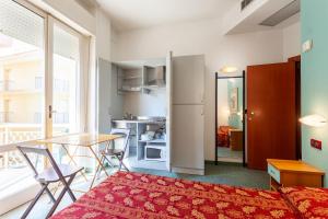 a small apartment with a table and chairs and a kitchen at Residence & Suites in Bellaria-Igea Marina