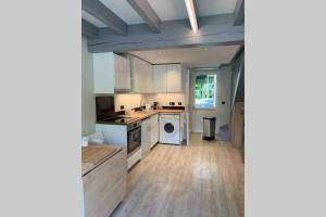 a kitchen with white cabinets and a washer and dryer at appartement residence avec piscine à anglet limite Biarritz in Anglet