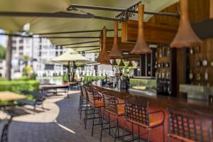 a bar with a bunch of chairs and tables at Barcelo Royal Beach Private Apartment in Sunny Beach
