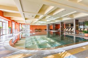 a large pool in the middle of a building at Barcelo Royal Beach Private Apartment in Sunny Beach
