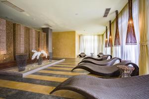 a lobby with a row of chairs and a fireplace at Barcelo Royal Beach Private Apartment in Sunny Beach