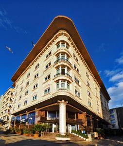 a large white building with a pointed roof at Hotel Bulvar Palas in Istanbul