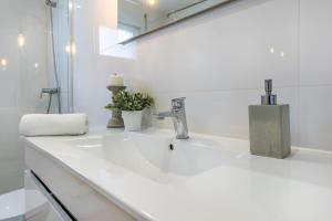 a bathroom with a white sink with a faucet at Charming Country House in Ourém +34 photos