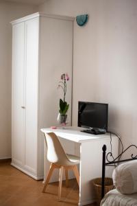 a white desk with a computer on top of it at Il Sasso di San Galgano in Chiusdino