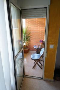 a sliding glass door leading to a patio with a table at El Valle in Murcia