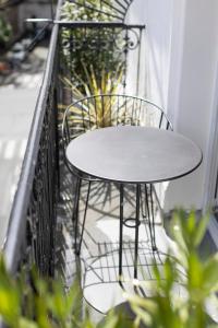 a table and chairs on a balcony with plants at Hôtel Oratio in Paris