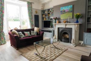 a living room with a couch and a fireplace at MonkBridge House in York