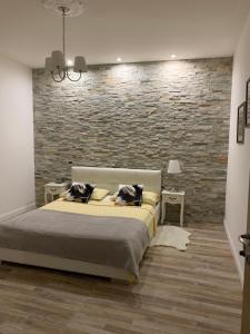 a bedroom with a bed and a brick wall at Galleno house in Galleno +43 photos