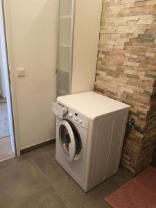 a washer and dryer in a room with a brick wall at Apartment Daum - Deine Ferienwohnung in Mühlbach am Hochkönig in Mühlbach am Hochkönig