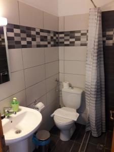 a bathroom with a toilet and a sink at Sea&Park View in Skala Marion