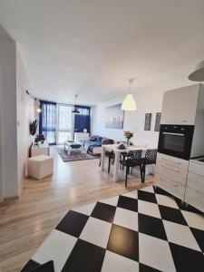 a kitchen and living room with a checkered floor at Apartament Centrum Jana Pawła II in Warsaw
