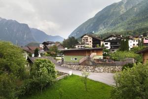 a village with houses and mountains in the background at Freestyle Apartment in Sautens