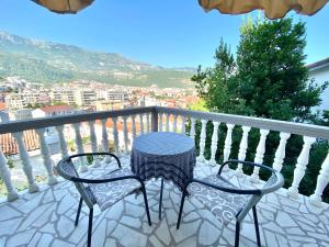 a table and chairs on a balcony with a view at Apartments Popović in Budva
