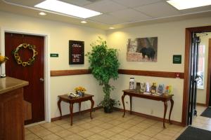 a waiting room with two tables and a bear on the wall at Yellowstone Lodge in West Yellowstone