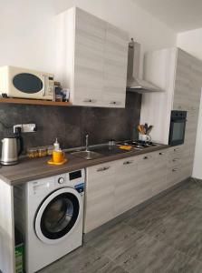 a kitchen with a washing machine and a microwave at Bayview in Pembroke +12 photos