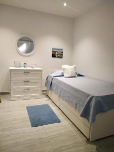 a bedroom with a bed and a dresser with a mirror at Bayview in Pembroke