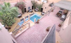 a patio area with a pool table and chairs at Guest House Bagdad Café in Aït Benhaddou