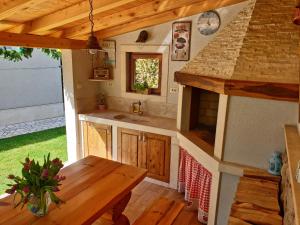 a kitchen with a sink and a wooden table at Apartment Kiara in Kraljevica