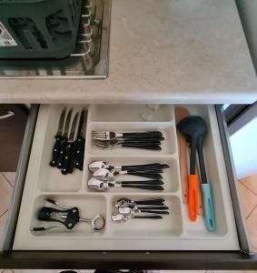 a drawer filled with utensils on a tray at Villa Keramidi in Limenaria