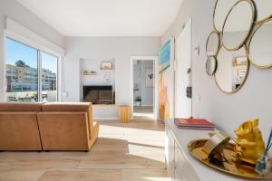 a living room with a couch and a table at Natural Grey Albufeira in Albufeira +44 photos