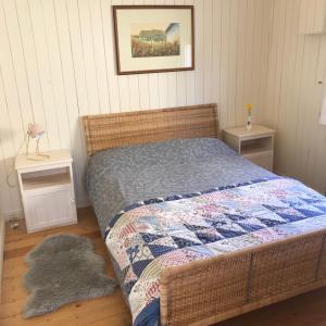 ein Schlafzimmer mit einem Bett mit einer Decke darauf in der Unterkunft Mo's Cottage in Kilmore