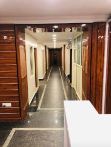a hallway in a building with a long corridor at Orchid Home in Bengaluru