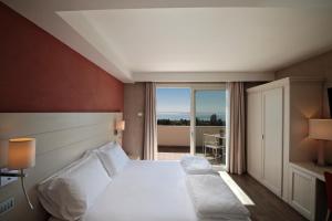 a hotel room with a bed and a large window at H2O ROOMS in Moniga