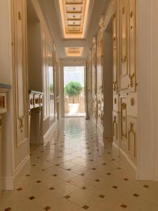 a hallway with a tiled floor in a building at Opera Arte Rooms in Porto Recanati