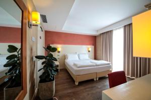 A bed or beds in a room at H2O ROOMS