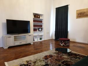 a living room with a flat screen tv on a entertainment center at RoyalGuest Apartment in Koper