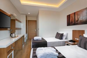 a hotel room with two beds and a tv at Le Marden Hotel Spa in Tekirova