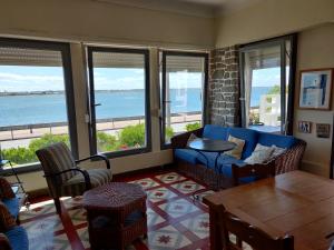 a living room with a view of the ocean at Casa Belo Horizonte in Praia da Barra