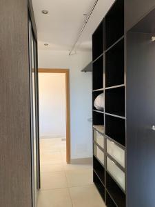 a walk in closet with black cabinets and a doorway at Maison vue mer Propriano Viggianello in Viggianello