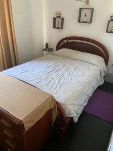 a bedroom with a large bed with a wooden frame at Quintinha do Zé da Lola in Silveiras