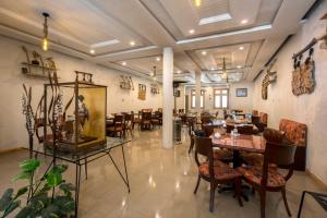 a restaurant with tables and chairs in a room at Gawalmandi Serenity Kalam in Kalām