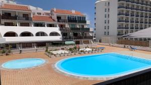 a large blue swimming pool on top of a building at Apartment Parque Royale 1 in Adeje