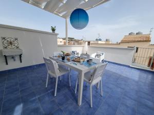 a white table and chairs on a patio at Le petite Maison in San Vito lo Capo