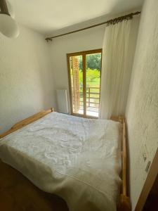 a bed in a room with a window at Apartment Olive Grove in Izola