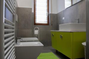 a bathroom with a white toilet and a sink at La tana dello zio Gio in Endine Gaiano