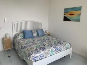 a bedroom with a bed with blue pillows on it at Casa Ministro in Positano