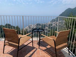two chairs and a table on a balcony with a view at Casa Ministro in Positano +14 photos