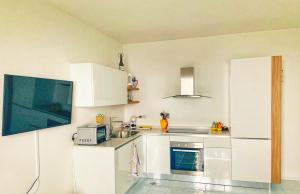 a kitchen with white cabinets and a microwave at Casa Ministro in Positano