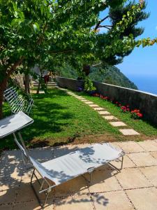a white chair sitting next to a table at Casa Ministro in Positano