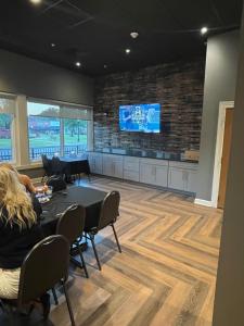 a room with a table and a tv on a wall at Meadows Hotel in South Fulton