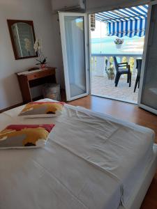 a bedroom with two beds and a view of a patio at Apartments Marijana in Zavalatica