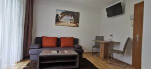 a living room with a couch and a table at Pension Alpina in Roppen