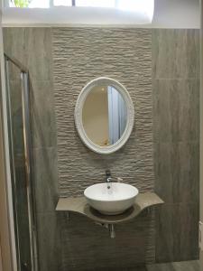 a bathroom with a sink and a mirror on the wall at Bayview in Pembroke